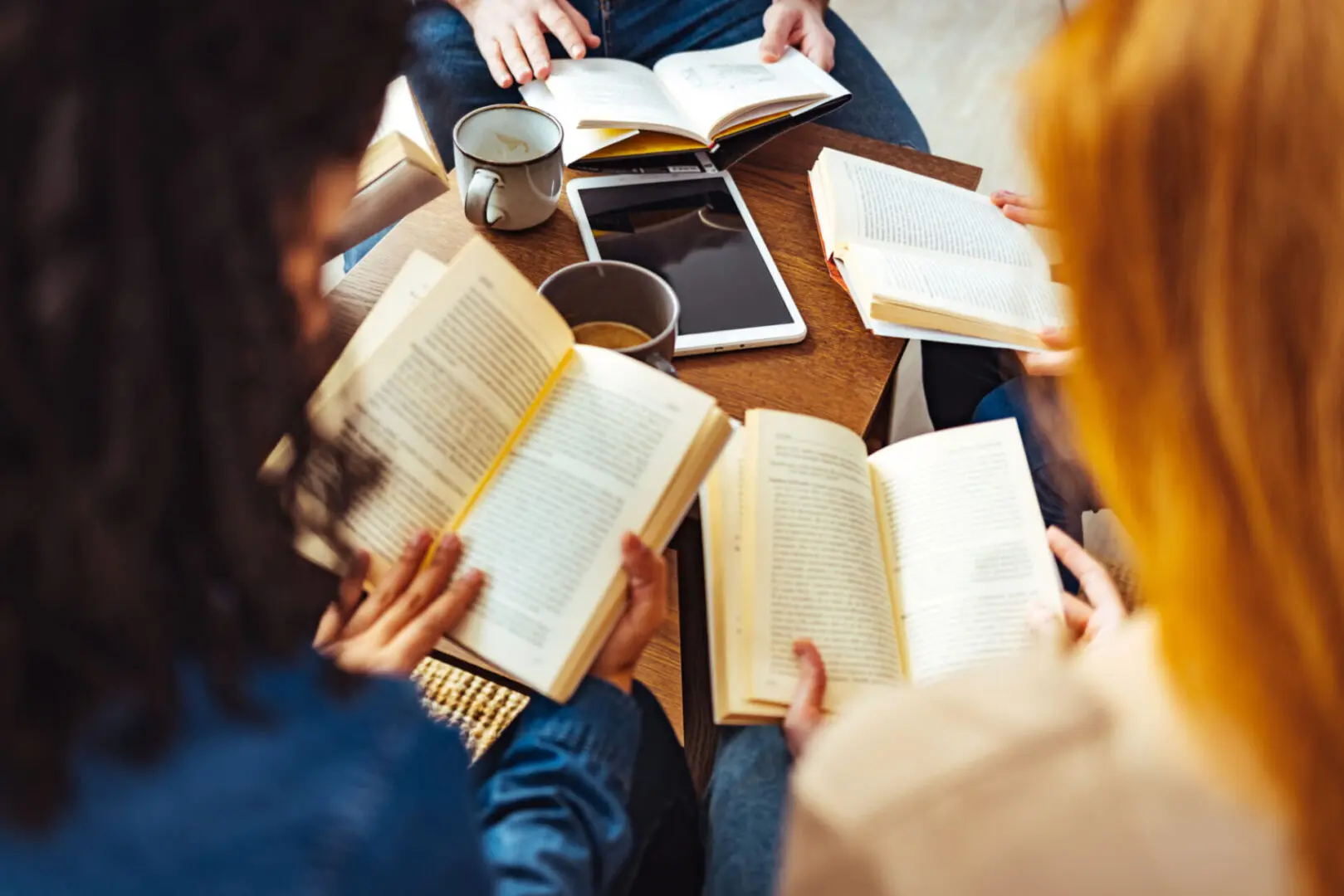 People reading books and drinking coffee